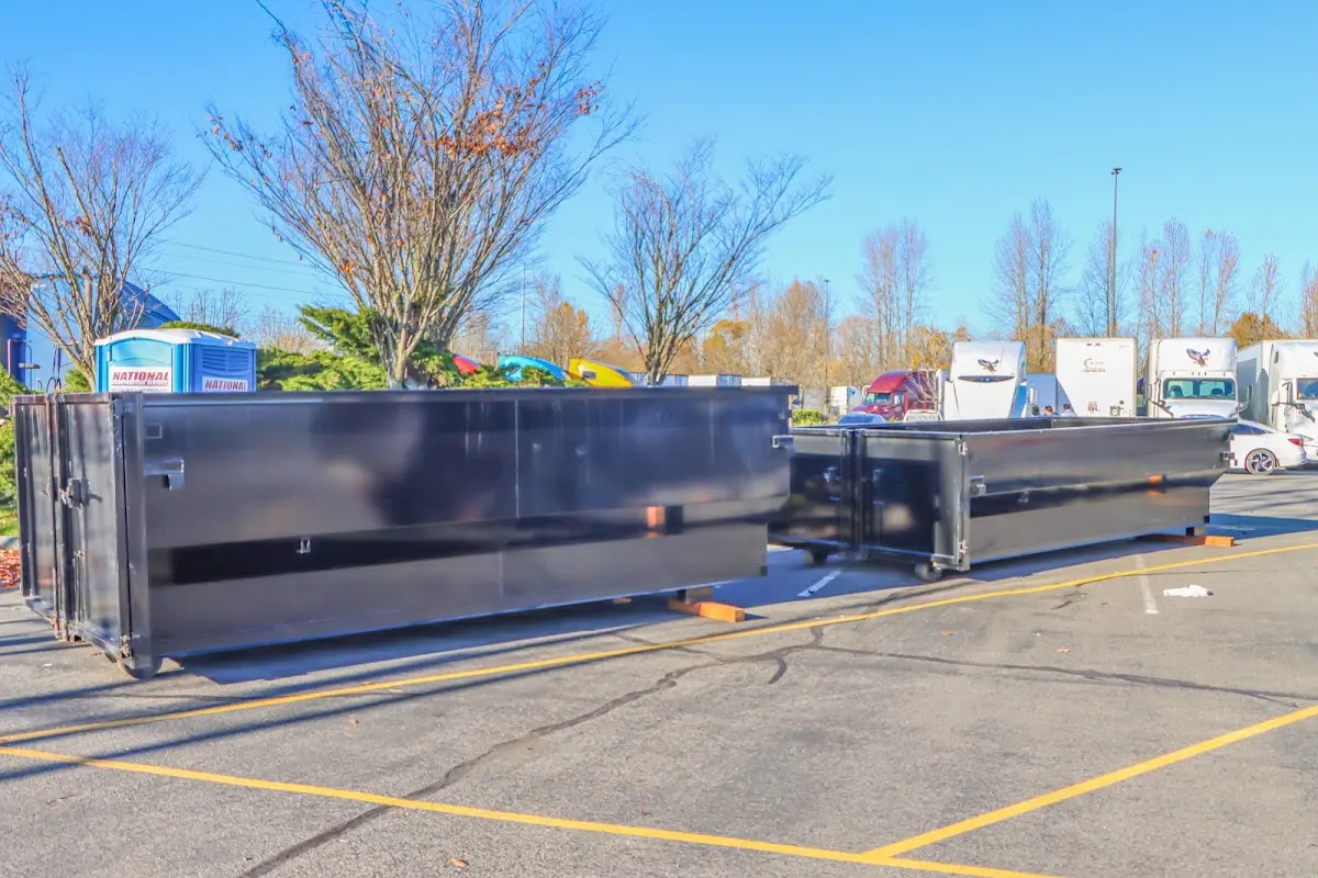 Professional dumpster rental service with roll-off container on residential driveway in Stuttgart